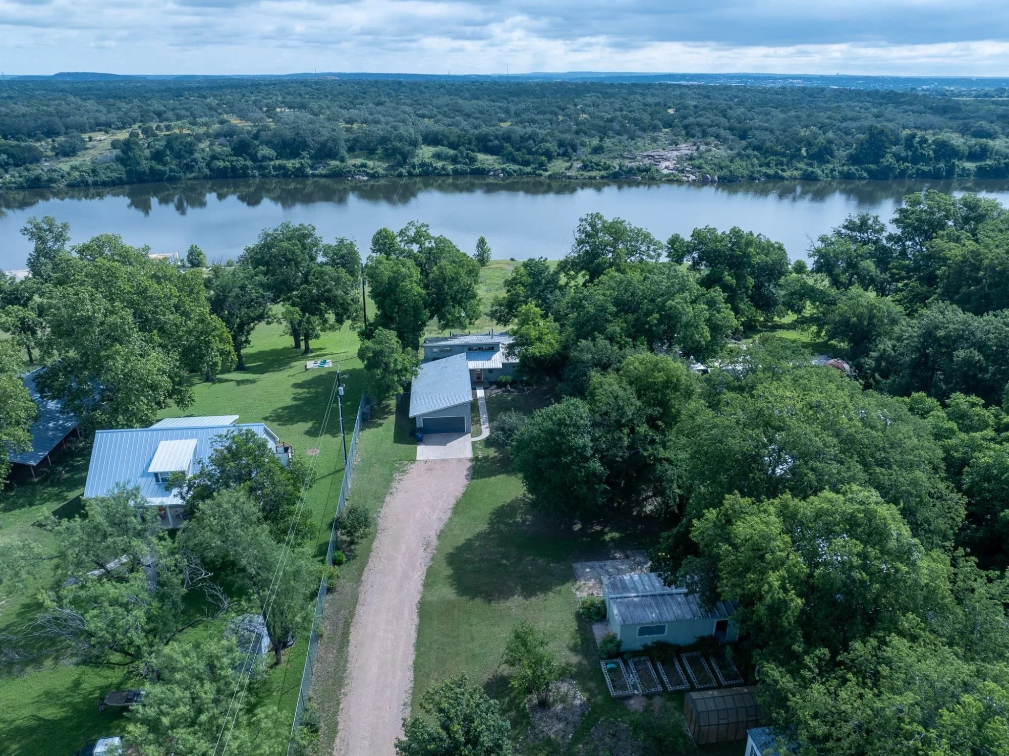 Aerial view of 3721 Lakeview Drive, a single-story home beside Lake Marble Falls in Cottonwood Shores.