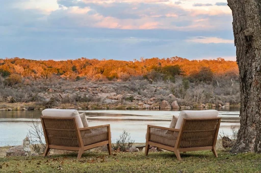 Two chairs on the lawn at 3721 Lakeview Drive, facing the lake at sunset.