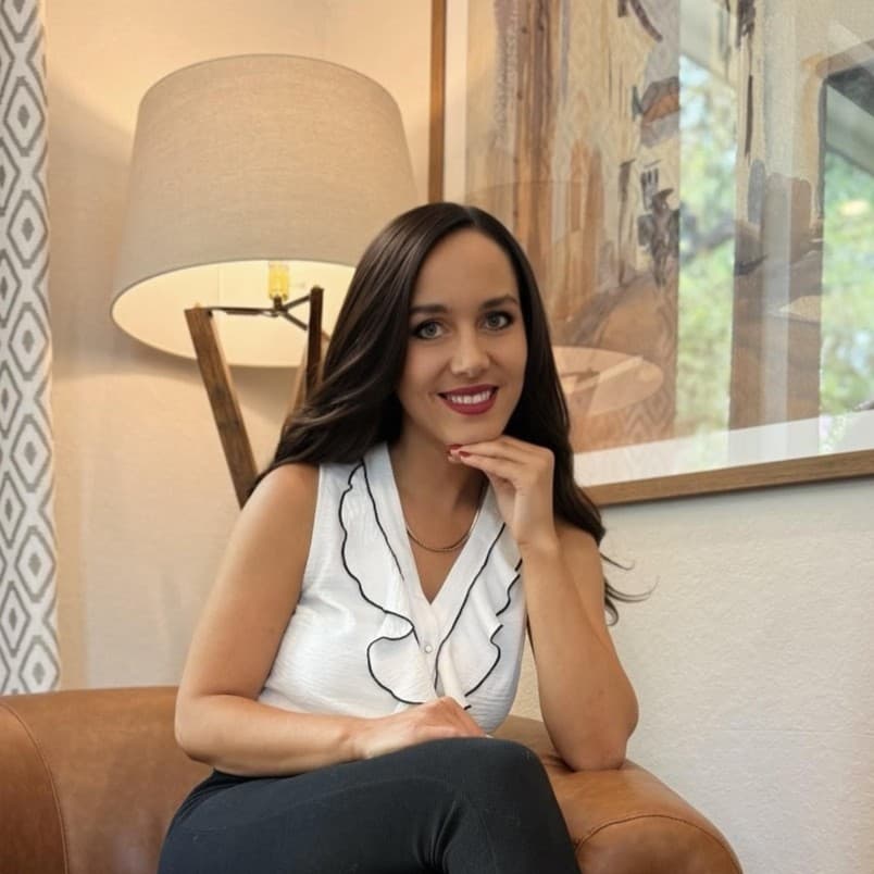Rachel Windley, a Texas REALTOR with LPT Realty, seated on a leather chair and smiling